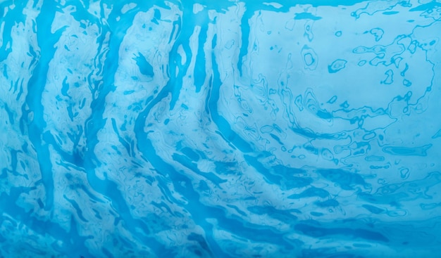 Foto onde d'acqua blu trasparenti sfocate sfocate sulla superficie dello sfondo blu dell'acqua