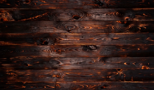 De gebrande achtergrond van de houten raadstextuur