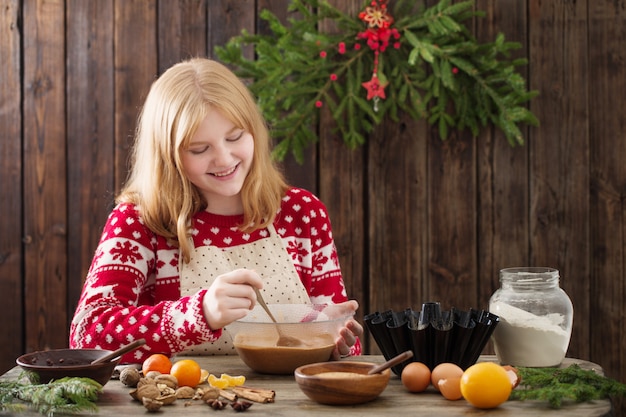 De gelukkige cake van meisjes kokende Kerstmis