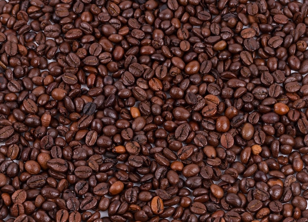 De geroosterde die textuur van koffiebonen als achtergrond wordt gebruikt