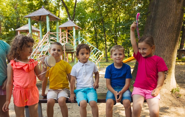 De groep kinderen rust uit in het zomerpark