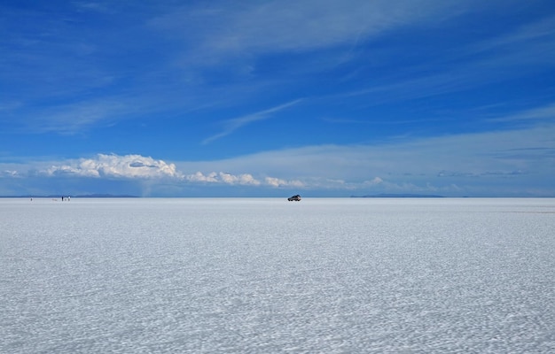 De grootste zoutvlaktes ter wereld met een parkeerwagen in Salar de Uyuni in Bolivia, Zuid-Amerika