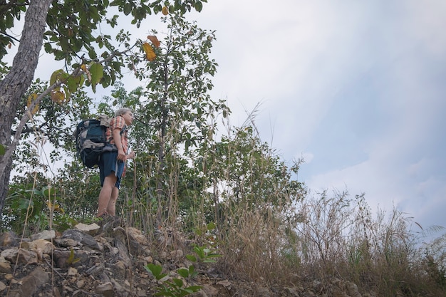 De jonge mens trekker geniet van reizend met rugzak, wandelingsconcept, reisconcept