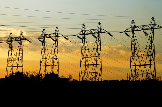 De macht van hoogspanningstorens bij zonsondergang