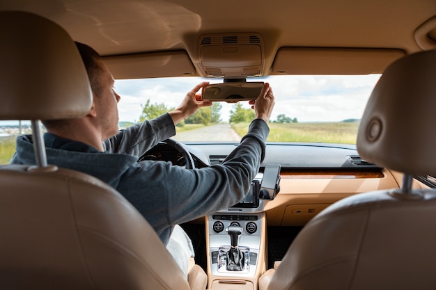 De man die de moderne auto bestuurt