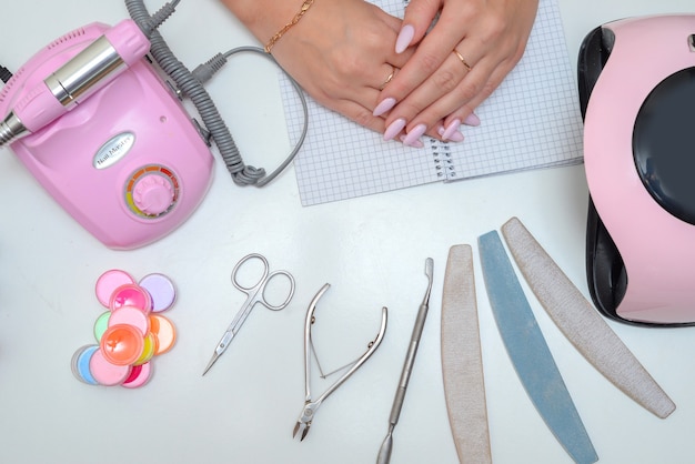 de meester maakt een manicure in de salon vrouwelijke handen close-up