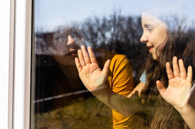 Foto de meiden blijven bij het raam en genieten van het weer