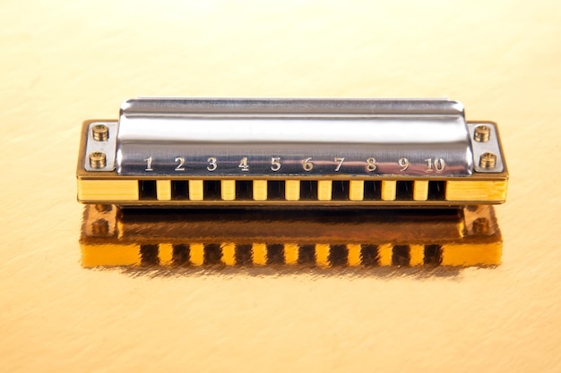 Foto de mondharmonica ligt op een gespiegeld oppervlak klassieke muzikale blaasinstrument