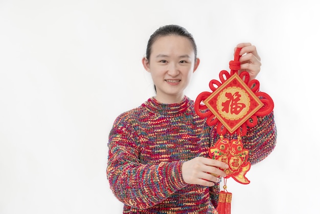 De mooie vrouw heeft een Chinese knoop met gelukstekens in haar hand