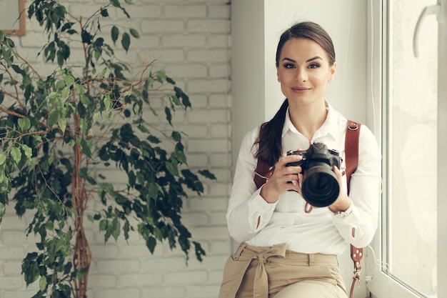 De mooie vrouw is een professionele fotograaf met dslrcamera