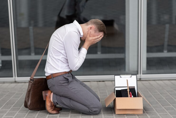 De ontslagen kantoormedewerker viel op zijn knieën en bedekte zijn gezicht vanwege stress.