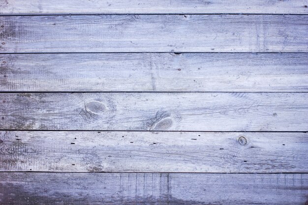 De oude achtergrond van de schuur houten blauwe grijze plank deur gedrapeerde textuur