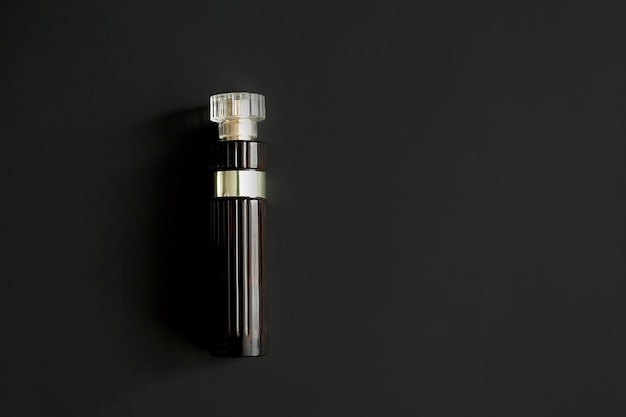 Foto de parfumfles is donkerrood op een donkere achtergrond. een.