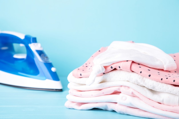 De pasgeboren kleren van het babymeisje met ijzer op blauwe, hoogste mening