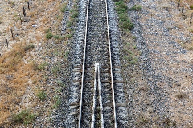 De spoorlijn in de steppe van Kazachstan, uitzicht op de rails vanaf de brug