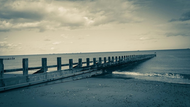 Foto de steiger bij de rustige zee tegen de lucht.