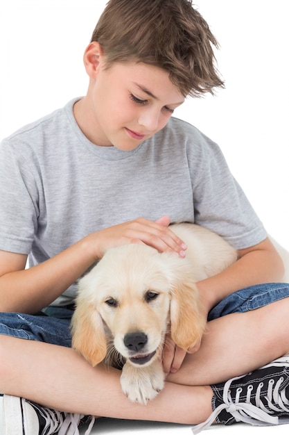 De strelende hond van de jongen over witte achtergrond