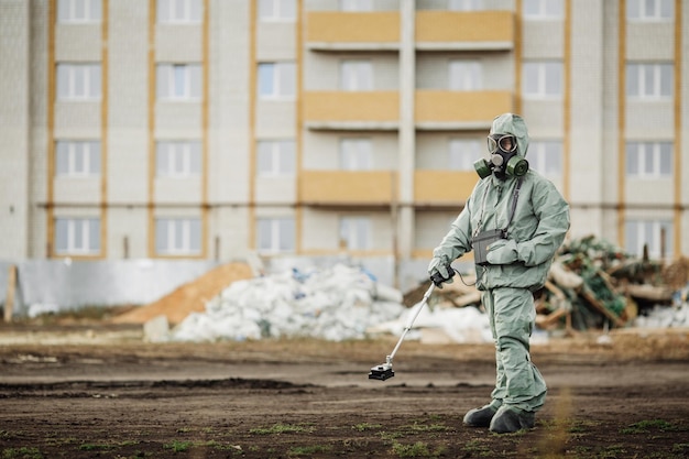 De teller van de stralingssupervisor van de wetenschapper controleert het niveau van radioactieve straling in de gevarenzone