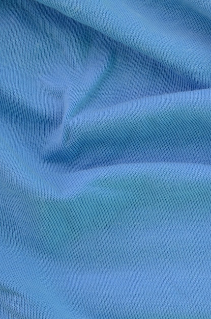 De textuur van de stof in blauwe kleur. Materiaal voor het maken van shirts en blouses