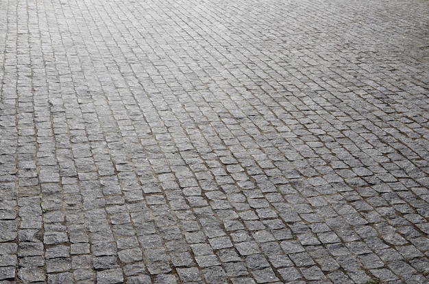 De textuur van de straatsteen (straatstenen) van velen