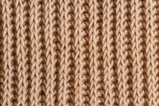 De textuur van een bruin gebreid garen. Gebreide en winterkleding