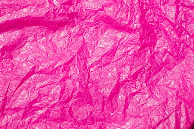De textuur van verfrommeld roze papier Papier voor het verpakken van geschenken en bloemen Abstracte achtergrond gemaakt van tishyu-papier
