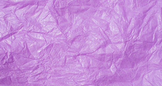 De textuur van verfrommeld roze papier Papier voor het verpakken van geschenken en bloemen Abstracte achtergrond gemaakt van tishyu-papier