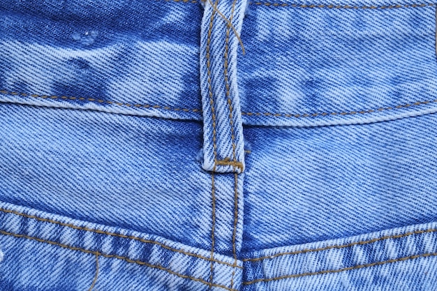 De textuurachtergrond van denimjeans met achterzakken