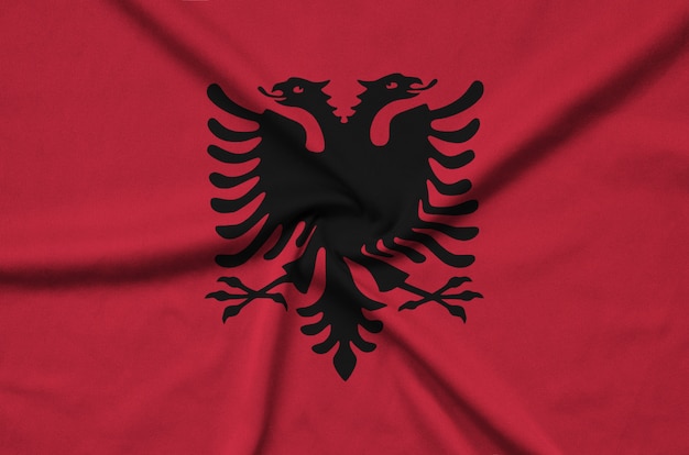 De vlag van Albanië is afgebeeld op een sportdoek met veel plooien.