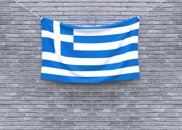 Foto de vlag van griekenland het hangen op bakstenen muur