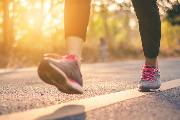 De voeten van de vrouwenagent op weg in het concept van trainingwellness.