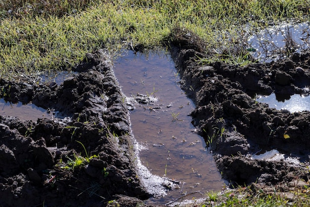 De weg in het veld staat volledig onder water na het verkeer