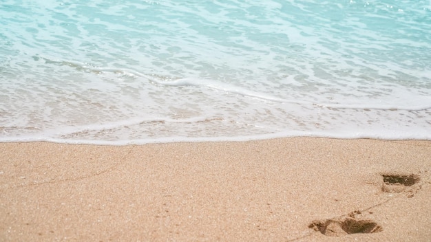 De zonnige oceaangolven van het de zomerstrand met bellen en zandachtergrond