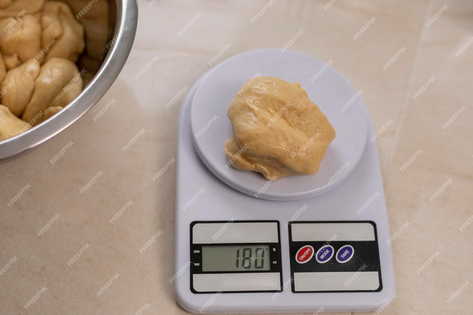 Premium Photo  Dead bread dough on a scale to weigh the poricones of the  bread