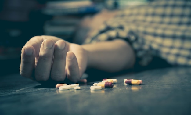 Photo dead man with medicines lying on floor at home