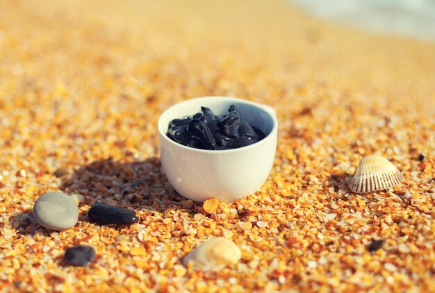 Dead Sea mud in a cup on the seashore