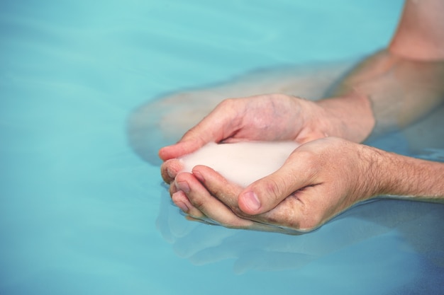 Dead Sea salt in male hands