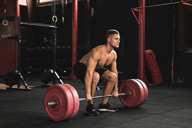 Deadlift exercise. Man during his workout in the gym