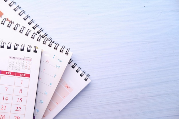 Photo deadline concept with stack of calendar on table with copy space