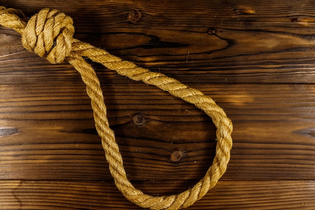 Deadly loop of rope on a wooden background Concept of death penalty or suicide