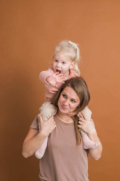 Deaf child girl with cochlear implant studying to hear sounds and have fun with mother recovery after cochlear Implant surgery and rehabilitation concept