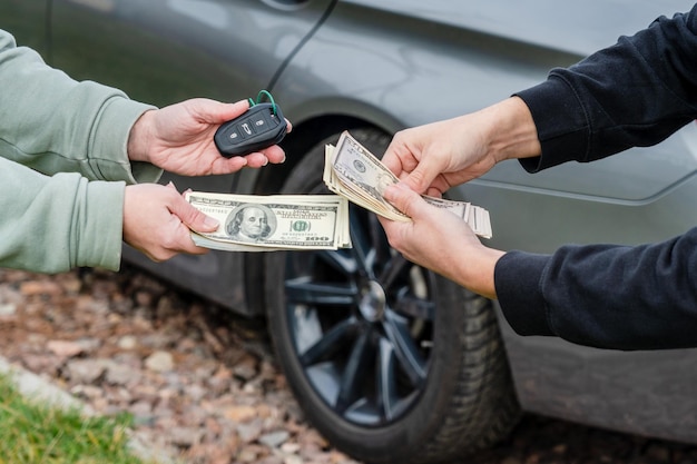 Deal of buying or renting car concept Exchange dollars and car keys