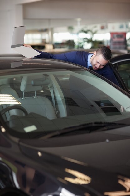 Dealer looking into a car