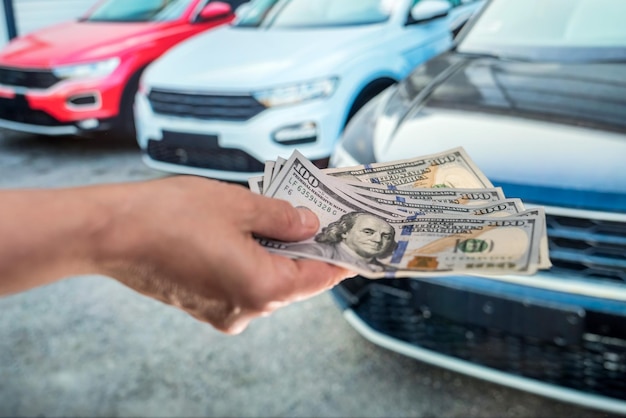 Photo dealer make agreement to buy a new car, man holding dollar. purchase concept