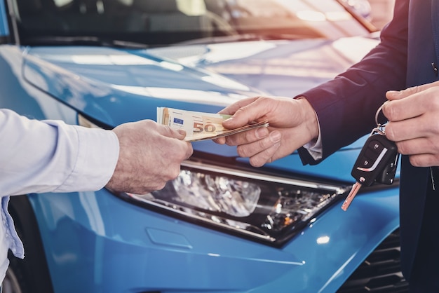 Photo dealer receiving money from client close up