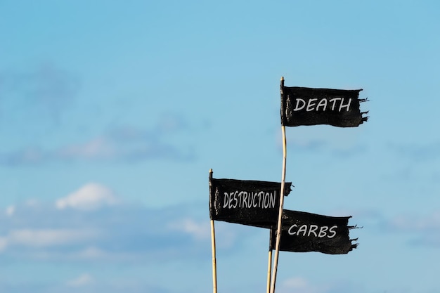 Photo death destruction carbs written on three black flags