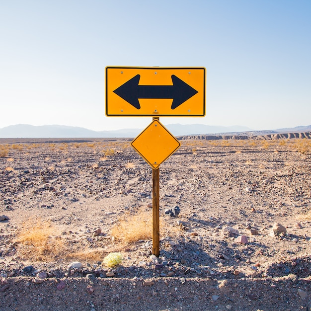 Death valley, california. direction sign in the middle of the desert.