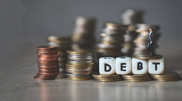 Photo debt business economy of money and finance word debt on coins with business man payment of taxes and of debt to the state concept of financial