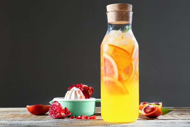 Decanter of fresh citrus cocktail on table