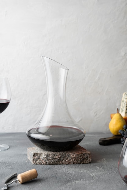 Decanter and red wine glass on table